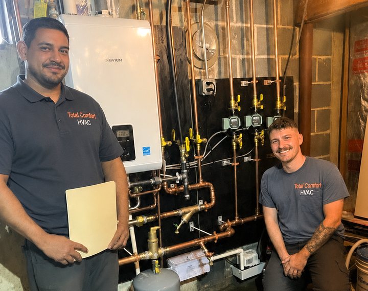 HVAC technicians by a boiler installation
